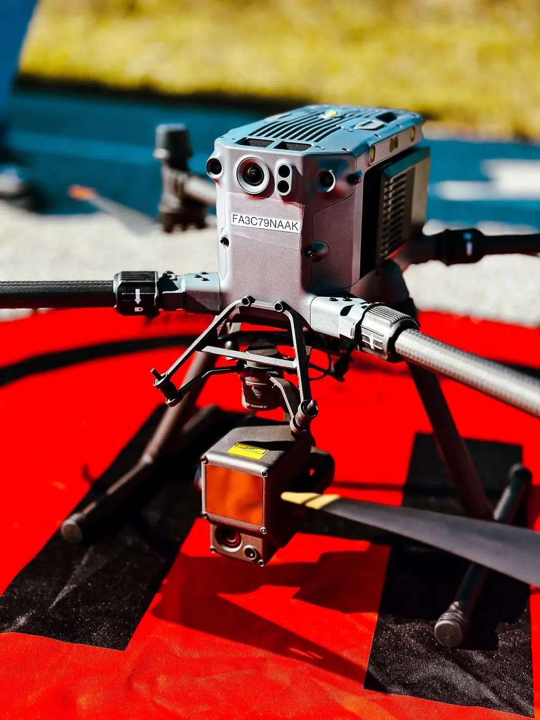Drone pilot operating a controller in the field.