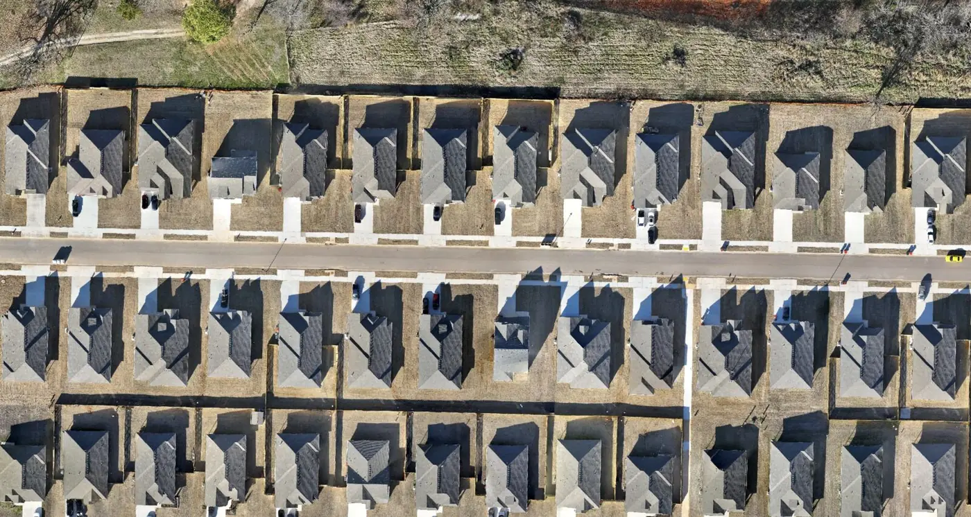 Later-stage orthomosaic of a residential development with homes roofed and driveways poured