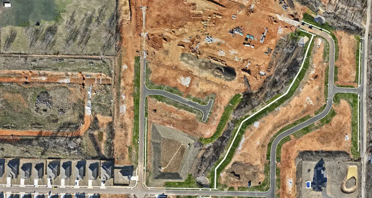 2D orthomosaic of a construction site showing graded earth, new roads and completed lots