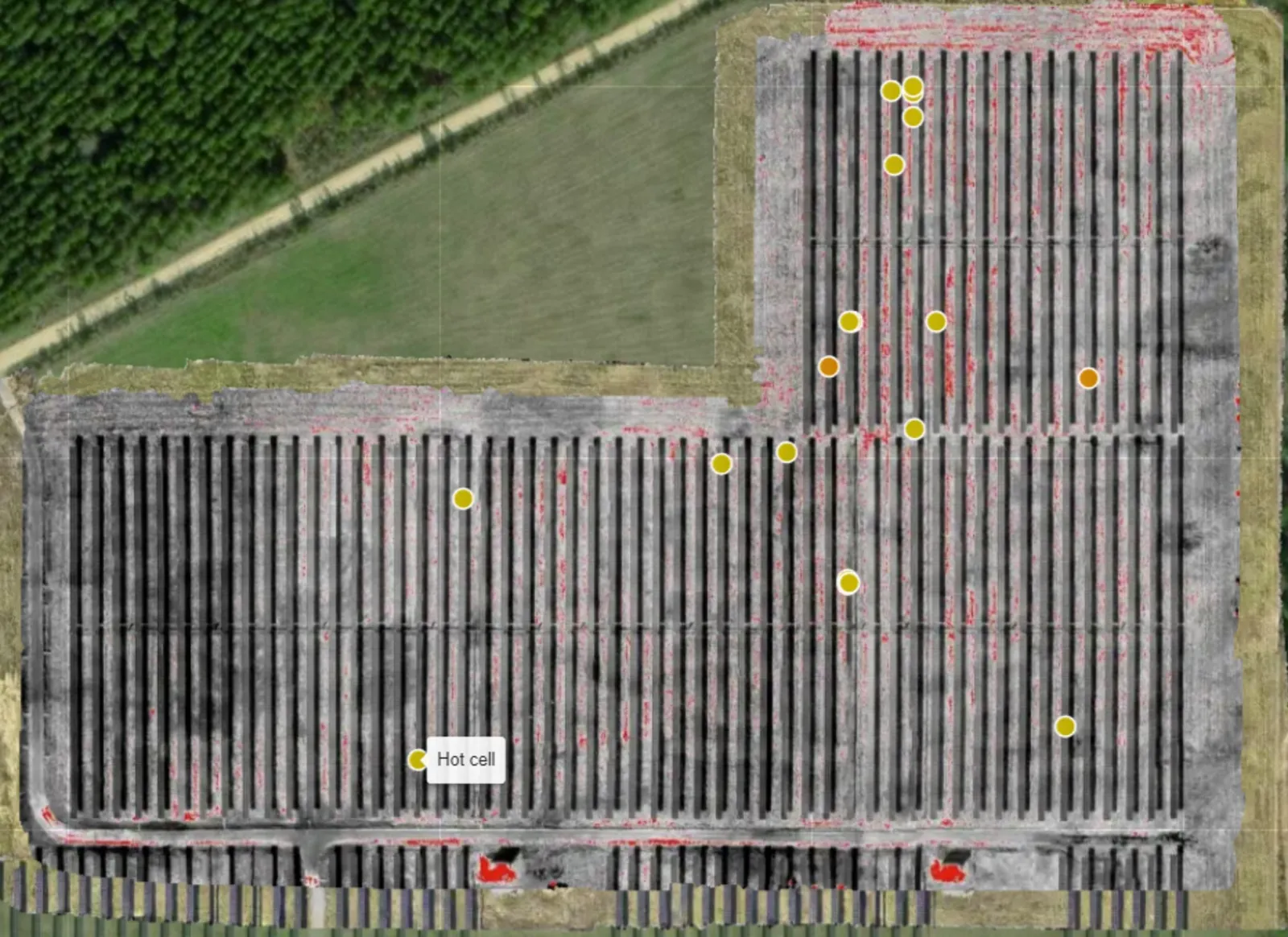 Site-wide thermal map of a municipal solar farm with every detected hot cell marked; yellow markers indicate low severity and orange medium.